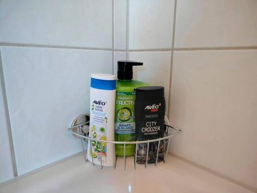 a shelf with bottles of hair products on a counter at Ruhiges Studio mit Aussicht fast bis nach Interlaken in Faulensee