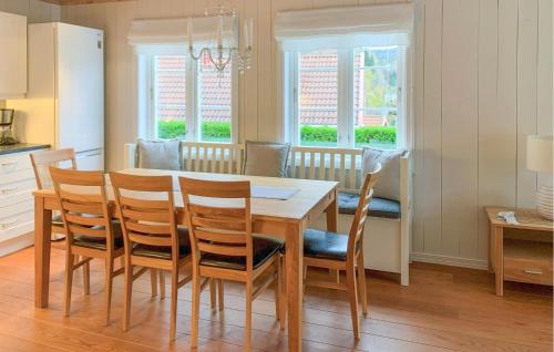 a kitchen and dining room with a table and chairs at Gorgeous Home In Risør With Wifi in Risør