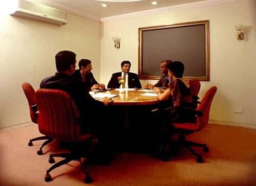 a group of people sitting around a table at Sarovar Portico Rivera Ahmedabad in Ahmedabad
