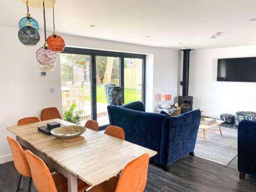 a living room with a wooden table and chairs at Lakeway in Penrith