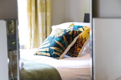 a reflection of a bed with pillows in a mirror at Lakeway in Penrith