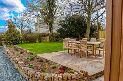 a patio with a table and chairs in a yard at Lakeway in Penrith