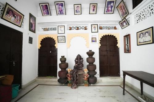 a room with two doors and pictures on the walls at Nukkad Guest House Near Lake Pichola in Udaipur