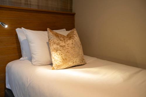 a pillow sitting on top of a bed at McKays Hotel in Pitlochry