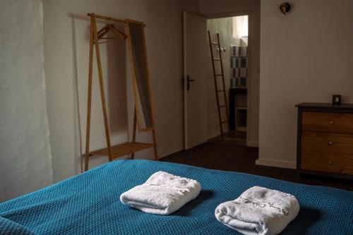 two towels are sitting on a bed in a room at Domaine de Cantelou in Clécy