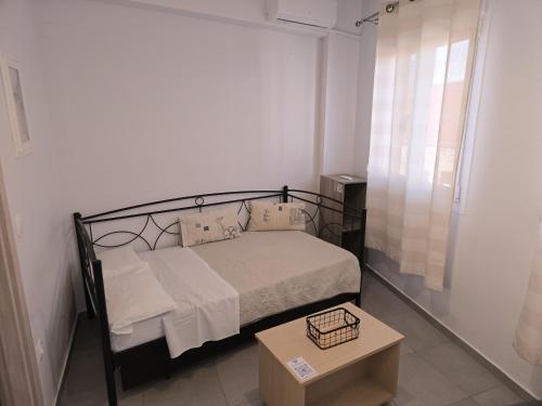 a small bedroom with a bed and a table at Αργέντη in Chios