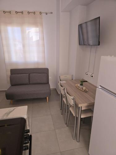 a living room with a table and a couch at Αργέντη in Chios