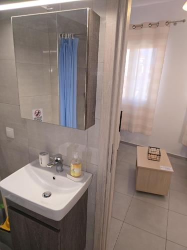 a bathroom with a sink and a shower at Αργέντη in Chios