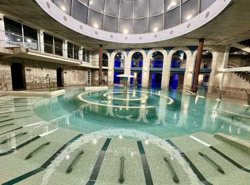 a swimming pool in a building with a domed ceiling at Balneario de Mondariz in Mondariz-Balneario