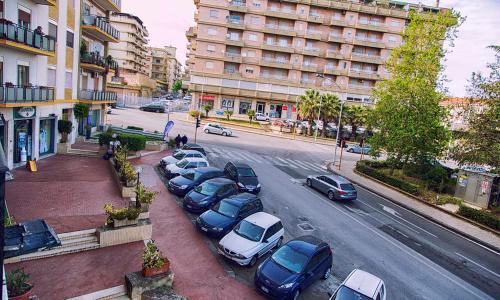 a group of cars parked on the side of a city street at Casa Di Amici in Caltanissetta