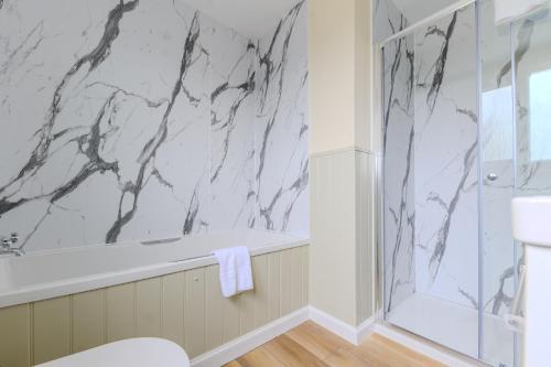 a bathroom with a black and white marble wall at Loch Ness Clansman Hotel in Drumnadrochit