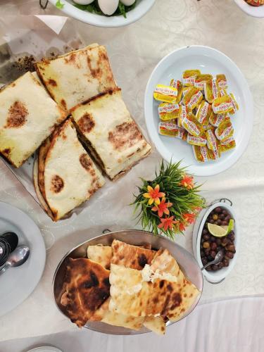 a table topped with plates of food and dips at Hotel and Restaurant Shallalat Anjar in ‘Anjar