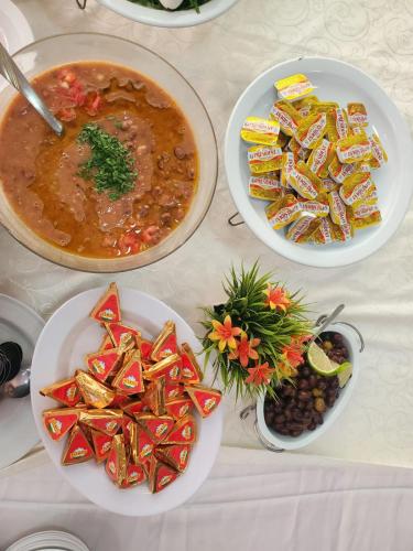 a table with plates of food and bowls of soup at Hotel and Restaurant Shallalat Anjar in ‘Anjar