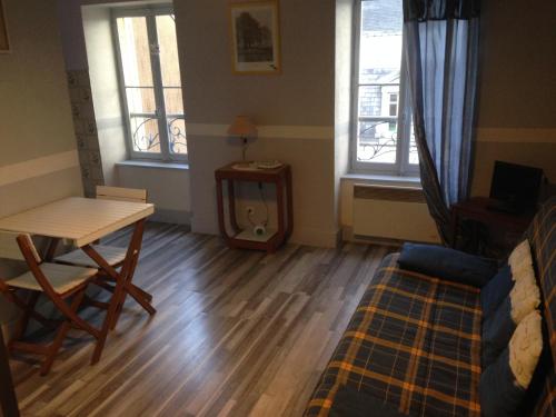孔特勒克塞維爾的住宿－皮亞琴察一室公寓，客厅配有桌子和桌椅
