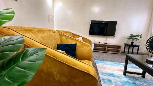 a living room with a couch and a flat screen tv at Res'Zac in Rufisque
