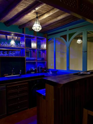 a bar with blue lighting in a room at Riad Madinina in Marrakech