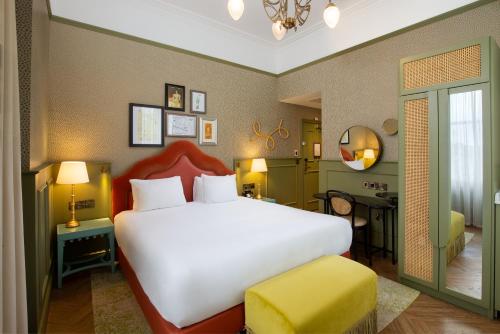 a bedroom with a large white bed and a desk at Elmbank York, Tapestry Collection by Hilton in York