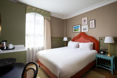 a bedroom with a large white bed and a window at Elmbank York, Tapestry Collection by Hilton in York