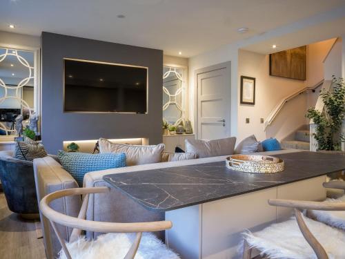 a kitchen and living room with a table and chairs at Arran Shores 3 in Lamlash