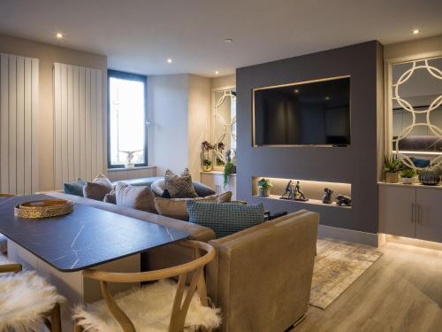 a living room with a couch and a table at Arran Shores 3 in Lamlash