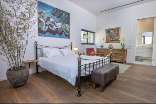 a bedroom with a bed and a potted plant at New Luxurious Villa in Kerem Maharal in Kerem Maharal