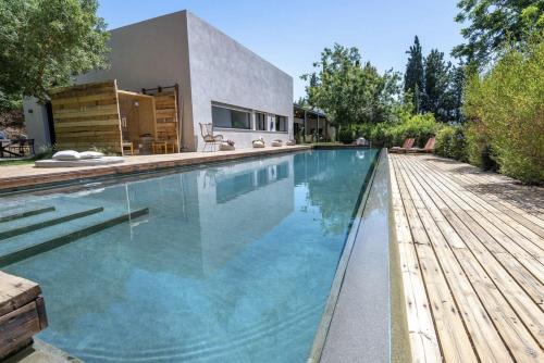 a swimming pool in front of a house at New Luxurious Villa in Kerem Maharal in Kerem Maharal