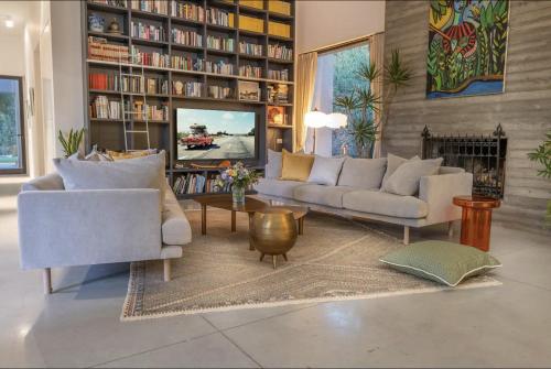 a living room with two couches and a fireplace at New Luxurious Villa in Kerem Maharal in Kerem Maharal