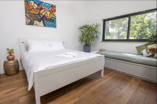 a bedroom with a white bed and a window at New Luxurious Villa in Kerem Maharal in Kerem Maharal