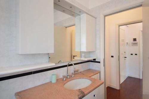 a bathroom with a sink and a mirror at Appartamento Gabbiano in Rapallo