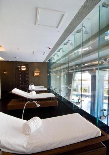two beds in a room with glass walls at Grand Lisboa Macau in Macau