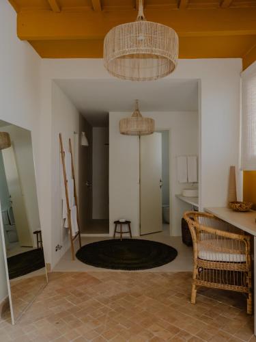 a living room with a table and chairs and a ceiling at Amagatay Luxury Boutique Hotel - Adults Only in Alaior