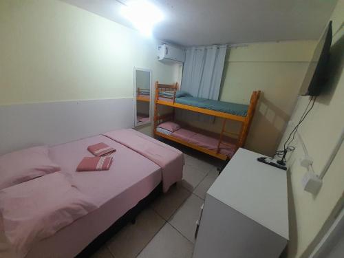 a small room with two bunk beds in it at Pousada cafe com margarida 150 metros do mar rua do calçadao da central in Balneário Camboriú