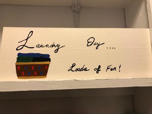 a sign that says happy day loads of fun on a shelf at Cliff’s Place in Iron Bridge