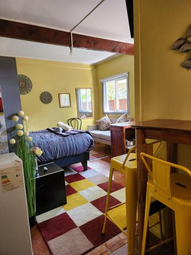 a bedroom with a bed and a living room at Kalas Cabañas in Puerto Varas