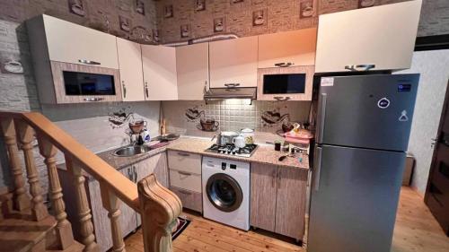 a kitchen with a refrigerator and a washing machine at Gabala Dreams in Gabala
