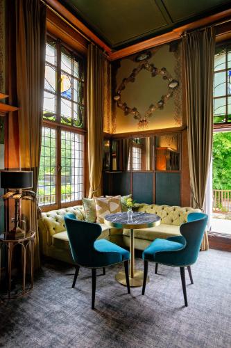 a living room with a couch and a table and chairs at Elmbank York, Tapestry Collection by Hilton in York