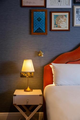 a bedroom with a bed and a lamp on a night stand at Elmbank York, Tapestry Collection by Hilton in York
