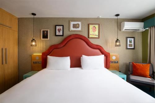 a bedroom with a large bed with white pillows at Elmbank York, Tapestry Collection by Hilton in York