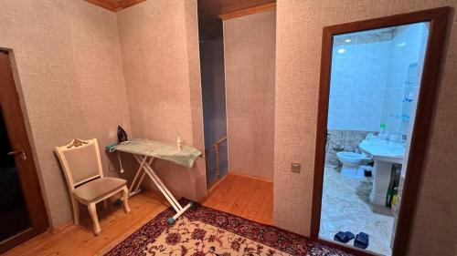 a bathroom with a sink and a table and a chair at Gabala Dreams in Gabala