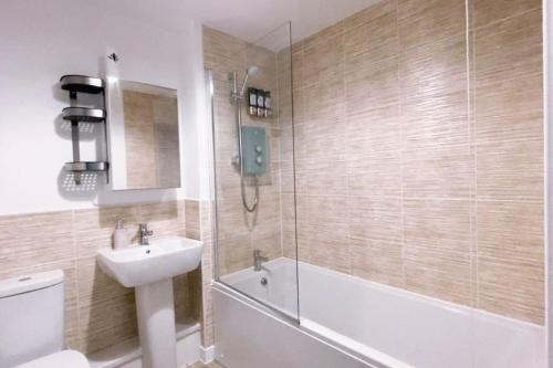 a bathroom with a sink and a toilet and a shower at Fabulous 2bedroom flat in Coventry