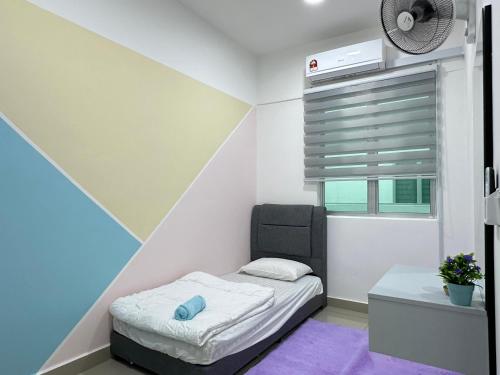 a small bedroom with a bed and a window at Bayu Temiang - 5pax Quiet Home in Seremban
