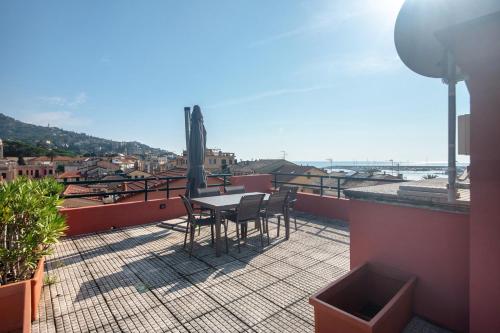 a patio with a table and chairs on a roof at Appartamento Gabbiano in Rapallo