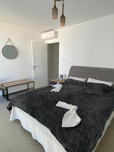 a bedroom with a large bed with white shoes on it at Blue Serenity - DeJa Blue 2 - C13 in Kalogrea