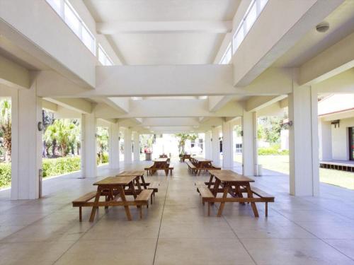 a hallway with tables and benches in a building at Nature Miraikan in Naha