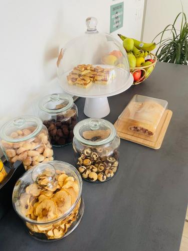 a table topped with bowls of food and a plate of fruit at Countryhouse Verso in Rovereto