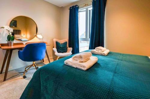 a bedroom with a bed and a desk and a mirror at York Central No 3, within the city walls, free parking in York