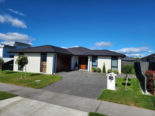 a house with a driveway in front of it at The Cozy Oasis in Napier