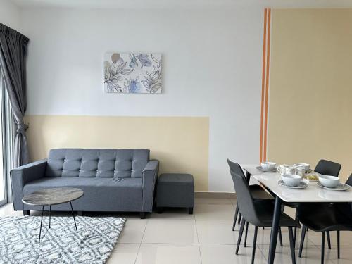 a living room with a couch and a table at Bayu Temiang - 5pax Quiet Home in Seremban