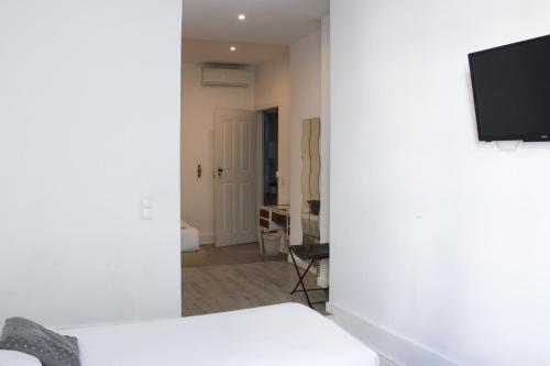 a living room with a bed and a tv in a room at Urban City in Aveiro