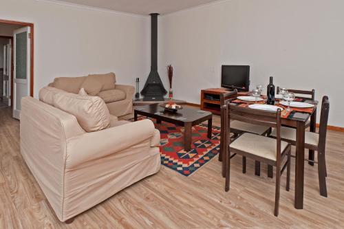 a living room with a couch and a table at La Galiniere Guest Cottages in Franschhoek
